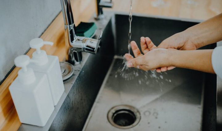 Cropped shot of a woman washing her hands thoroughly in the sink