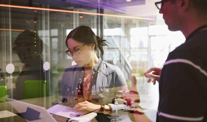 IT technicians with laptop working in network server room