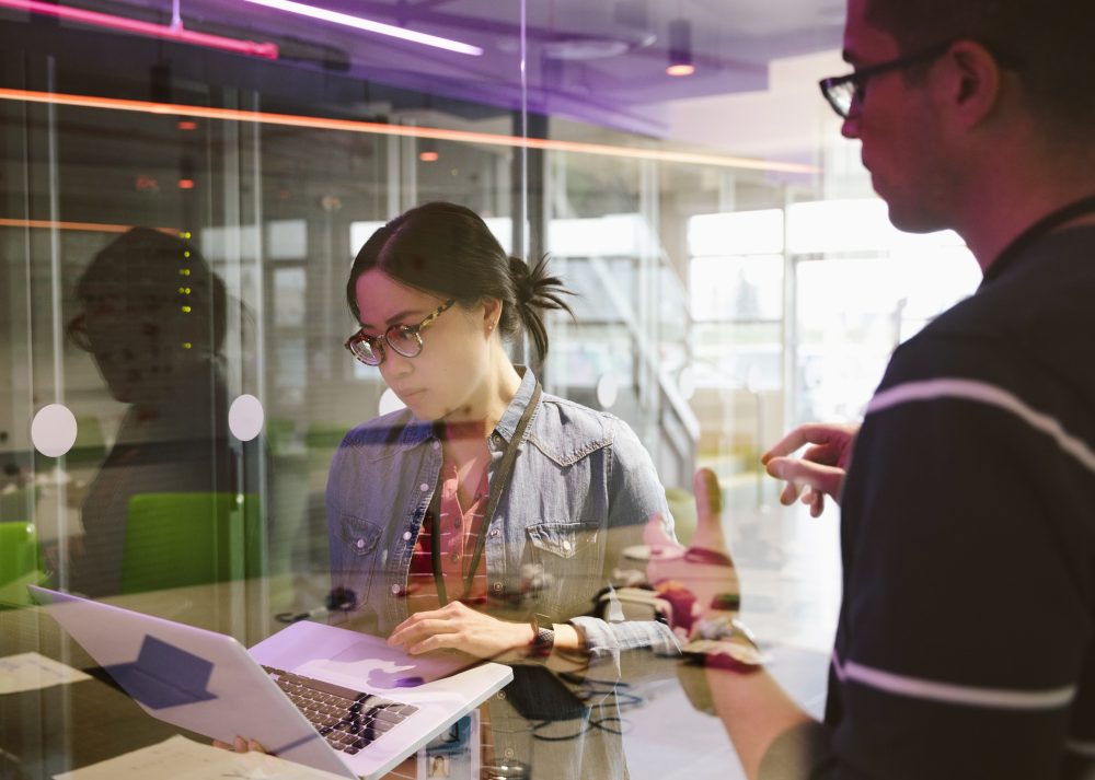 IT technicians with laptop working in network server room